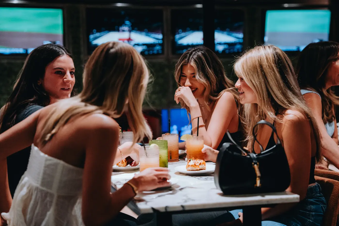 Friends sharing dinner at House Rules Scottsdale